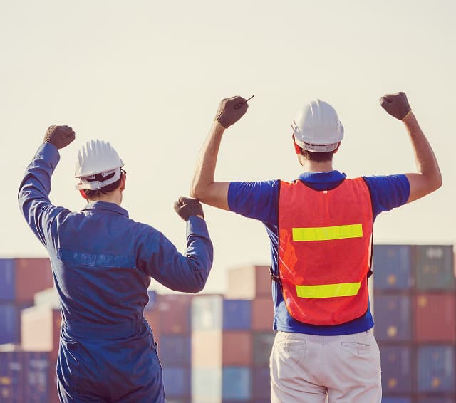 Workers at shipping container terminal